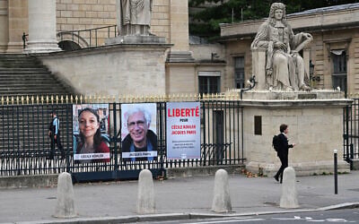 This photograph shows portrait placards of Cecile Kohler and Jacques Paris, two French citizens detained in Iran, set up on a fence of the French National Assembly, in Paris on October 6, 2025. (Photo by Martin LELIEVRE / AFP) This photograph shows portrait placards of Cecile Kohler and Jacques Paris, two French citizens detained in Iran, set up on a fence of the French National Assembly, in Paris on October 6, 2025. (Photo by Martin LELIEVRE / AFP)