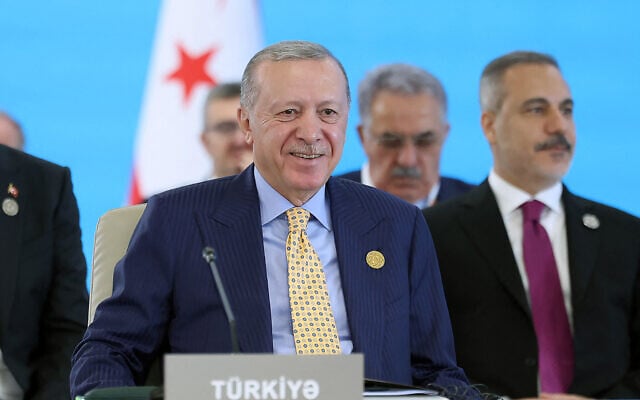This handout photograph taken and released by Turkish Presidency Press Office on October 7, 2025, shows Turkey's President Recep Tayyip Erdogan attending a session of the 12th Summit of the Organization of Turkic State (OTS) in Gabala, Azerbaijan. (Mustafa Kamaci / Turkish Presidency Press Office / AFP)