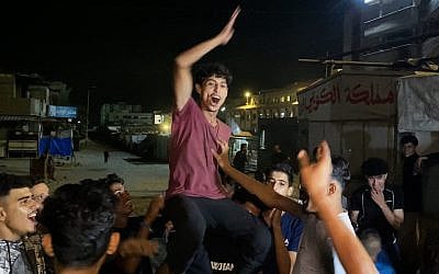 Palestinians celebrate in Khan Yunis on October 9, 2025, following news of a Gaza ceasefire deal. (AFP)