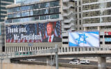 A billboard showing an image of US President Donald Trump to thank him for his role in reaching the first phase of a ceasefire-hostage deal with Hamas, and another one bearing Israel's national flag, are installed on a main highway in Tel Aviv on October 9, 2025 (Jack GUEZ / AFP)
