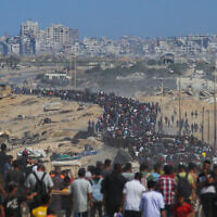 Palestinians walk along Al-Rashid Road toward Gaza City from Nuseirat in the central Gaza Strip, on October 10, 2025. (Bashar TALEB / AFP)