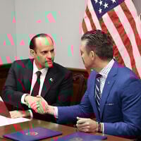 US Defense Secretary Pete Hegseth (R) and Qatari Defense Minister Sheikh Saoud bin Abdulrahman Al Thani shake hands after signing a letter of acceptance to establish a Qatari Emiri Air Force training facility at the Mountain Home Air Force Base in Idaho, at the Pentagon in Arlington, Virginia, on October 10, 2025. (Alex Wroblewski / AFP)