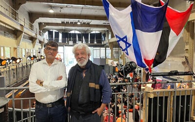 Edgar Laloum (R) and Radjaa Aboudagga founders of the restaurant "Sababa, le goût de la paix" (Sababa, the Taste of Peace) pose for a picture during the opening of the restaurant in Paris on October 11, 2025. (Antoine BOYER / AFP)