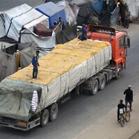 A humanitarian aid truck enters the Nusseirat refugee camp in the central Gaza Strip on October 12, 2025. (Eyad BABA / AFP)