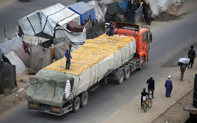 A humanitarian aid truck enters the Nusseirat refugee camp in the central Gaza Strip on October 12, 2025. (Eyad BABA / AFP) A humanitarian aid truck enters the Nusseirat refugee camp in the central Gaza Strip on October 12, 2025. (Eyad BABA / AFP)