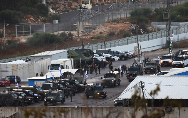 Israeli military armored vehicles take position at the Ofer military prison located between Ramallah and Beitunia in the West Bank on October 13, 2025, ahead of the release of Palestinian prisoners in exchange for hostages held by Hamas in Gaza since October 7, 2023 (HAZEM BADER / AFP)