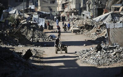 A man rides a donkey cart past destroyed buildings as displaced Palestinians return to their homes in the in al-Zahra area, north of the Nuseirat refugee camp in the central Gaza Strip, on October 14, 2025, amid the Gaza ceasefire brokered by US President Donald Trump. (Eyad BABA / AFP) A man rides a donkey cart past destroyed buildings as displaced Palestinians return to their homes in the in al-Zahra area, north of the Nuseirat refugee camp in the central Gaza Strip, on October 14, 2025, amid the Gaza ceasefire brokered by US President Donald Trump. (Eyad BABA / AFP)