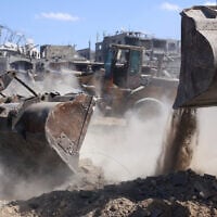 Bulldozers deployed by the Hamas-controlled Gaza Municipality clear building rubble from main axes and streets in Gaza City, amid a ceasefire between Israel and the Palestinian terror group, on October 14, 2025. (AFP)