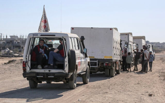 Vehicles of the International Committee of the Red Cross, including refrigerated trucks, prepare to depart for the Kissufim crossing, located east of Deir el-Balah in the central Gaza Strip, to receive the bodies of Palestinians that have been held in Israeli custody on October 15, 2025. (Bashar TALEB / AFP)