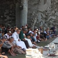 Gazans attend Friday prayers amidst the rubble of the destroyed Albaani Mosque in Khan Yunis in the southern Gaza Strip on October 17, 2025. (Omar AL-Qatta / AFP)