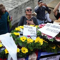 Mourners surround the coffin of slain hostage Bipin Joshi, before the repatriation of his body to Nepal, at Ben Gurion Airport, on October 19, 2025. (FADEL SENNA / AFP)