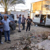 Civilians and members of the press inspect the damage following an Israeli strike that reportedly struck a house used by journalists in the al-Zawayda city near Deir al-Balah, in the central Gaza Strip, on October 19, 2025, (BASHAR TALEB / AFP)