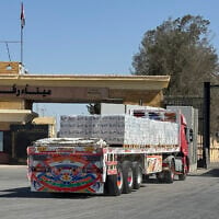 A truck loaded with humanitarian aid waits to cross from the Egyptian side of Rafah en route to the Kerem Shalom crossing into the Gaza Strip on October 20, 2025 (AFP)