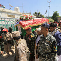 An honor guard carries the coffin of the military chief of Yemen's Houthi rebels, Major General Mohammed al-Ghamari, during a funeral procession for him four days after the group announced al-Ghamari's death in Sanaa, on October 20, 2025. (Mohammed HUWAIS / AFP)