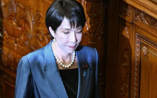 Liberal Democratic Party (LDP) President Sanae Takaichi walks back to her seat after casting her ballot during voting for Japan's new prime minister during an extraordinary session of the lower house of parliament in Tokyo on October 21, 2025.  (Photo by Philip FONG / AFP)