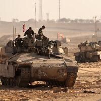 IDF troops deployed along the border between Israel and the Gaza Strip take position in their armored personnel carriers near the border fence on October 21, 2025. (Jack GUEZ / AFP)