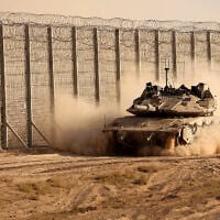 Israeli troops move along the border fence between Israel and the Gaza Strip on October 21, 2025. (Jack GUEZ / AFP)
