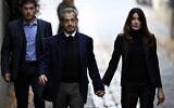 France's former president Nicolas Sarkozy (C), with his wife Carla Bruni-Sarkozy, leaves his residence to present himself to La Sante Prison for incarceration on a five-year prison sentence, on October 21, 2025. (JULIEN DE ROSA / AFP)