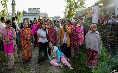 Family members mourn during the funeral ceremony of Bipin Joshi, a deceased Nepali agricultural student who was slain in Hamas captivity in the Gaza Strip, in Kanchanpur, Nepal, October 21, 2025. (PRAKASH CHANDRA TIMILSENA / AFP)