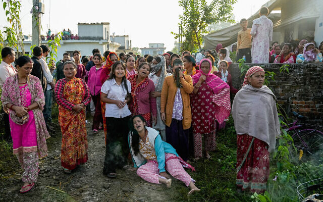 Family members mourn during the funeral ceremony of Bipin Joshi, a deceased Nepali agricultural student who was slain in Hamas captivity in the Gaza Strip, in Kanchanpur, Nepal, October 21, 2025. (PRAKASH CHANDRA TIMILSENA / AFP)