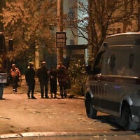 A Ukrainian medic helps local residents to leave the site of an airstrike in Kyiv on October 23, 2025, amid the Russian invasion of Ukraine. (Andrew Kravchenko/AFP)