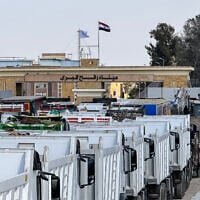 Egyptian trucks and heavy machinery line up on the Egyptian side of the Rafah border crossing with the Gaza Strip on October 26, 2025. (AFP)