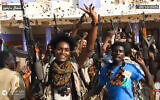 RSF fighters holding weapons and celebrating in the streets of El-Fasher in Sudan's Darfur region, in a screengrab of a video published on Telegram, on October 26, 2025. (Rapid Support Forces / AFP)