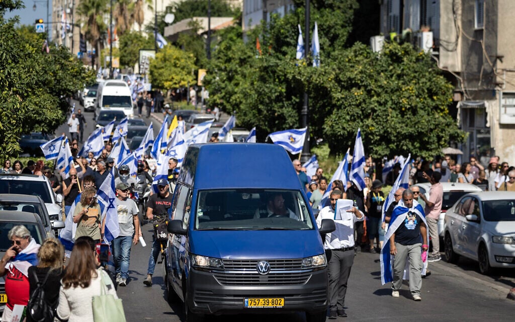 Mourners take part in the funeral procession of Yossi Sharabi, who was killed in captivity after being taken hostage during the October 7, 2023 attacks, in the central city of Rishon Letzion on October 27, 2025 (FADEL SENNA / AFP)