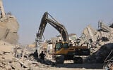 An excavator operates in the al-Tuffah neighborhood of Gaza City on October 27, 2025. (Omar AL-QATTAA / AFP)