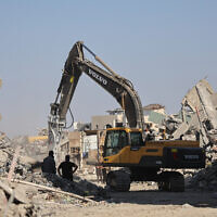 An excavator operates in the al-Tuffah neighborhood of Gaza City on October 27, 2025. (Omar AL-QATTAA / AFP)