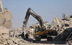 An excavator operates in the al-Tuffah neighborhood of Gaza City on October 27, 2025. (Omar AL-QATTAA / AFP)