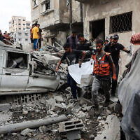 Palestinians recover a body from the rubble of a house destroyed in an overnight Israeli strike in Gaza City on October 29, 2025. (Omar AL-QATTAA / AFP)