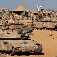 Israeli soldiers sit on top of tanks at a position in the south, near the Israel-Gaza border fence, on October 30, 2025 (Jack GUEZ / AFP)