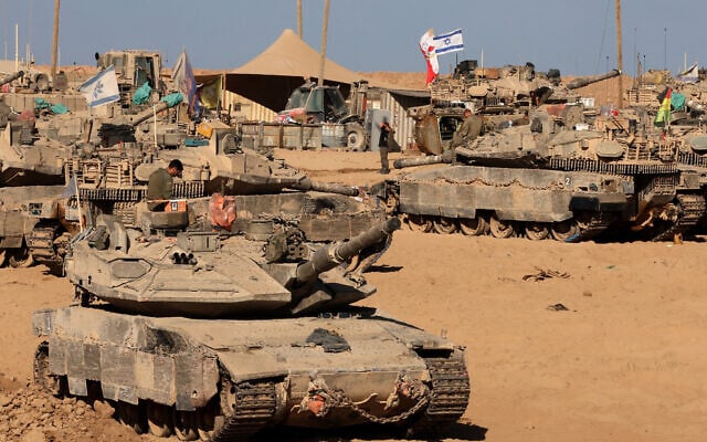 Israeli soldiers sit on top of tanks at a position in the south, near the Israel-Gaza border fence, on October 30, 2025 (Jack GUEZ / AFP)
