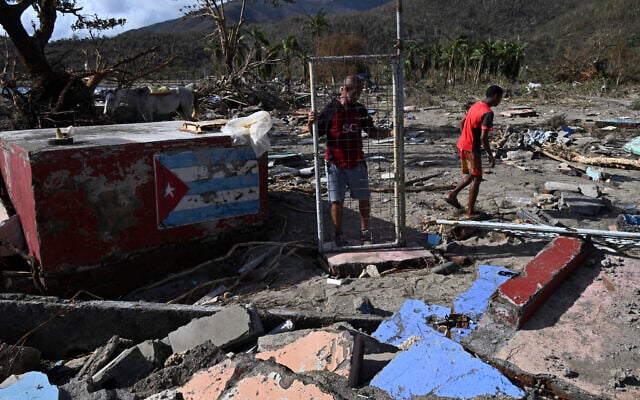 A man holds the gate of a damaged house after the passage of Hurricane Melissa in Boca de Dos Rios village, Santiago de Cuba province, Cuba on October 30, 2025. (Yamil Lage/AFP) A man holds the gate of a damaged house after the passage of Hurricane Melissa in Boca de Dos Rios village, Santiago de Cuba province, Cuba on October 30, 2025. (Yamil Lage/AFP)