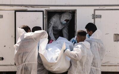 Employees of the Nasser Medical Complex unload one of the 30 bodies of  Palestinians released as part of the hostage-ceasefire deal, as the body bags arrive in Khan Yunis, in the southern Gaza Strip, on October 31, 2025. (AFP)