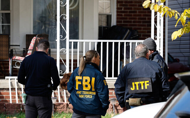 Members of the FBI Joint Terrorism Task Force stand in the front yard as they search a home in Dearborn, Michigan, on October 31, 2025. (JEFF KOWALSKY / AFP) Members of the FBI Joint Terrorism Task Force stand in the front yard as they search a home in Dearborn, Michigan, on October 31, 2025. (JEFF KOWALSKY / AFP)