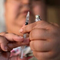 In this April 18, 2017, file photo, a woman with Type 2 diabetes prepares to inject herself with insulin at her home in Las Vegas. (AP/John Locher)
