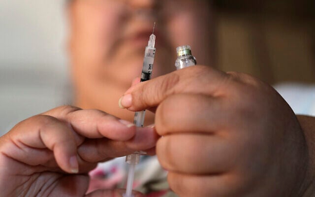 In this April 18, 2017, file photo, a woman with Type 2 diabetes prepares to inject herself with insulin at her home in Las Vegas. (AP/John Locher)