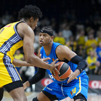Berlin's David McCormack, left, and Tel Aviv's Jasiel Rivero challenge for the ball during the Basketball EuroLeague match between Alba Berlin and Maccabi Tel Aviv in Berlin, Germany, November 28, 2024. (AP Photo/Markus Schreiber)