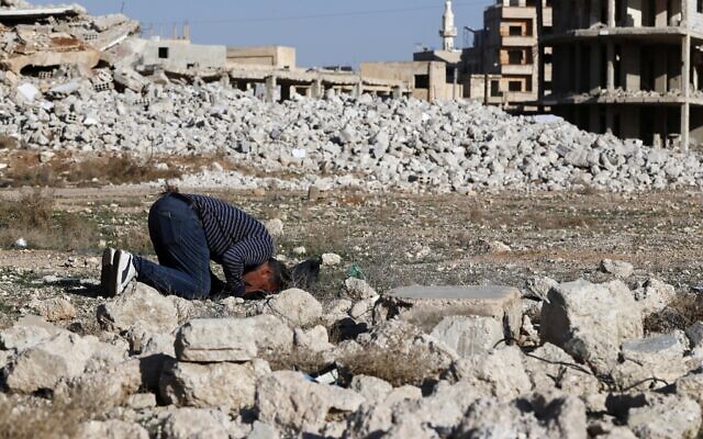Saeed Kamel, who recently returned after the fall of Bashar Assad, prays in a destroyed area of Daraya, Syria, March 17, 2025. (AP/Omar Sanadiki) Saeed Kamel, who recently returned after the fall of Bashar Assad, prays in a destroyed area of Daraya, Syria, March 17, 2025. (AP/Omar Sanadiki)