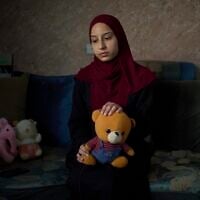 Tayma Asous, 26, holds the favorite toy of her 2-year-old daughter, Layla Al-Khatib, who was killed after being shot in the head by alleged Israeli gunfire, at their home in the village of Muthallath ash-Shuhada, near the West Bank city of Jenin, March 11, 2025. (AP Photo/Leo Correa)
