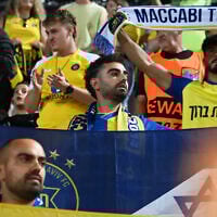 Maccabi Tel Aviv's fans clap hands after the end of the Europa League soccer match between PAOK and Maccabi Tel Aviv at Toumpa stadium, in Thessaloniki, Greece, September 24, 2025. (AP Photo/Giannis Papanikos)