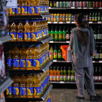 A customer shops in a supermarket at a shopping mall in northern Tehran, Iran, September 28, 2025. (AP Photo/Vahid Salemi)