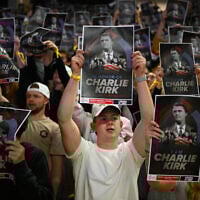 People hold posters of Charlie Kirk during a Turning Point USA rally at Utah State University, as a part of the organization's push to memorialize Kirk, Tuesday, Sept. 30, 2025, in Logan, Utah. (AP Photo/Alex Goodlett)