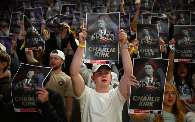 People hold posters of Charlie Kirk during a Turning Point USA rally at Utah State University, as a part of the organization's push to memorialize Kirk, Tuesday, Sept. 30, 2025, in Logan, Utah. (AP Photo/Alex Goodlett)