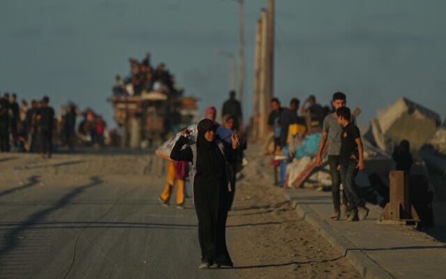 Displaced Palestinians flee northern Gaza carrying their belongings along the coastal road near Wadi Gaza on October 1, 2025. (AP/Jehad Alshrafi) Displaced Palestinians flee northern Gaza carrying their belongings along the coastal road near Wadi Gaza on October 1, 2025. (AP/Jehad Alshrafi)