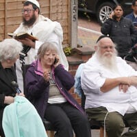 Congregants seen outside Heaton Park Hebrew Congregation synagogue, in Crumpsall, Manchester, England, after a deadly terrorist attack, Oct. 2, 2025. (AP Photo/Ian Hodgson)
