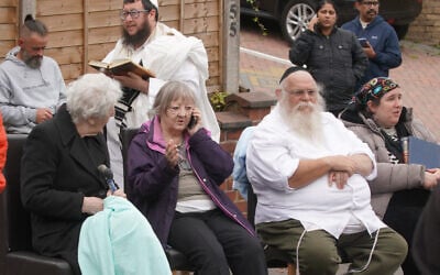 Congregants seen outside Heaton Park Hebrew Congregation synagogue, in Crumpsall, Manchester, England, after a deadly terrorist attack, Oct. 2, 2025. (AP Photo/Ian Hodgson)