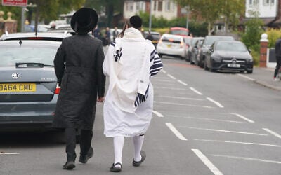 Orthodox Jewish men walk near the scene of a deadly terror attack at Heaton Park Hebrew Congregation synagogue, in Crumpsall, Manchester, England, October 2, 2025. (AP Photo/Ian Hodgson) Orthodox Jewish men walk near the scene of a deadly terror attack at Heaton Park Hebrew Congregation synagogue, in Crumpsall, Manchester, England, October 2, 2025. (AP Photo/Ian Hodgson)